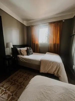 a bedroom with two beds and a window at Wilder Lodge in Fairmont Hot Springs