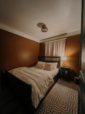 a bedroom with a bed and a table with a lamp at Wilder Lodge in Fairmont Hot Springs