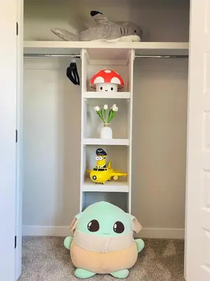 a childs closet with a shelf with toys at The Downtown Oasis - A Spacious Family Friendly 3 Bedroom House Close to Everything in Edmonton