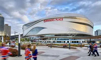a crowd of people walking in front of a soccer building at The Private Central Edmonton Suite - Comfortable & Fully-Equipped Basement Suite in Edmonton