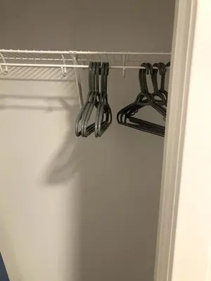 a bunch of utensils hanging on a rack in a kitchen at Cozy 2 Bedroom Apartment in Calgary