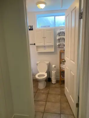 a bathroom with a toilet and a window at Your Home Away From Home in Abbotsford