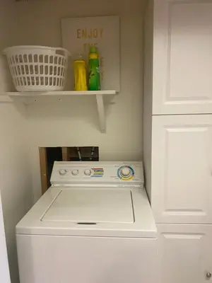 a white stove in a kitchen with a white cabinet at Your Home Away From Home in Abbotsford