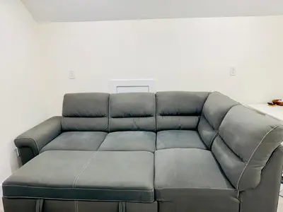 a gray couch in a living room at One-Bedroom Suite in Gibsons in Gibsons