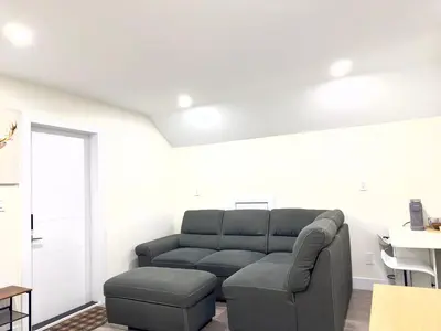 a living room with a couch and a table at One-Bedroom Suite in Gibsons in Gibsons