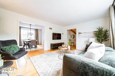 a living room with a couch and a table at Nordic Spa Retreat - Hot Tub - King Bed - Firepit - BBQ in Edmonton