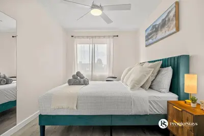 a bedroom with a bed and a ceiling fan at Downtown 17th Ave Lifestyle with Secure Parking and AC in Calgary