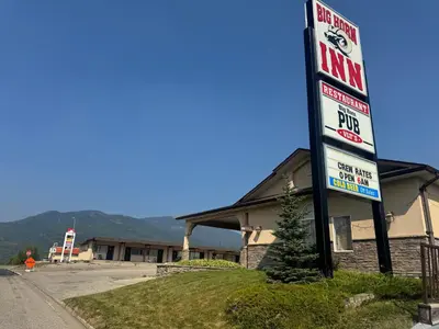 a gas station sign in front of a building at Big Horn motor Inn in Grande Cache