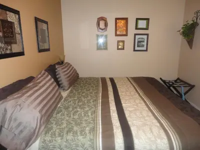 a bedroom with a bed with two pillows on it at Vintage Merlot Bed and Breakfast in Oliver
