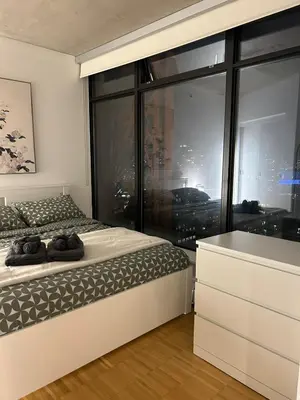 a bedroom with a bed and a large window at Cozy Gastown condo with a view! in Vancouver