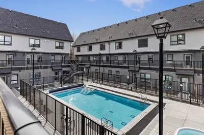 a large swimming pool in front of a building at Peak n Plunge Insane MTN View Pool n Hot Tub K201 in Canmore