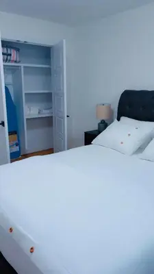a bedroom with a white bed and a closet at Lucas in Edmonton