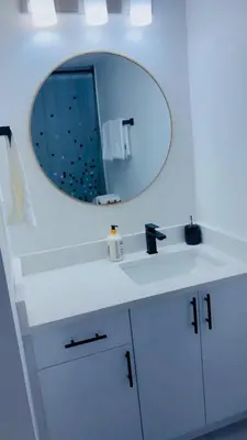 a bathroom with a white sink and a mirror at Lucas in Edmonton