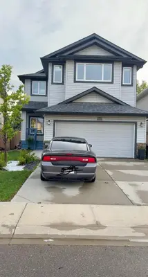 a car parked in a driveway in front of a house at Lucas in Edmonton