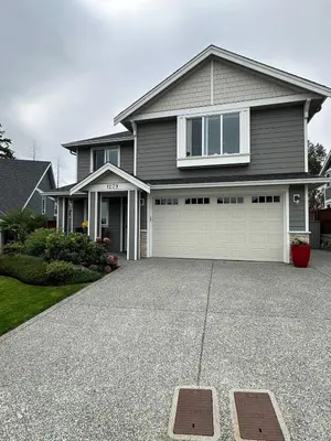 a house with a driveway and a garage at Modern One-Bedroom Retreat in Bear Mountain in Langford