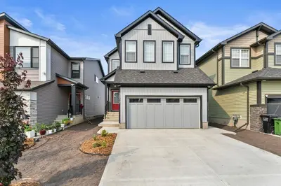 a large house with a garage in a driveway at Classic 2 Bed-Basement Near the lake in Edmonton