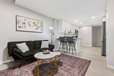 a living room with a couch and a table at Classic 2 Bed-Basement Near the lake in Edmonton