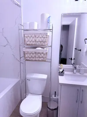 a white bathroom with a toilet and a sink at Lush 1 Bedroom house with WiFi in Edmonton in Edmonton