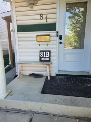 a house with a door with a sign on it at Calgary Super Cozy Guest Rooms Near Banff in Calgary