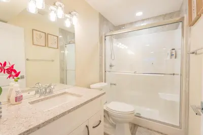 a bathroom with a sink and a toilet and a shower at Anna Suite Rental in Edmonton