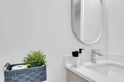 a bathroom with a sink and a mirror at Basement in Calgary - 10 Mins from Calgary Airport in Calgary