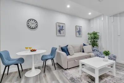 a living room with a couch and a table and chairs at Basement in Calgary - 10 Mins from Calgary Airport in Calgary