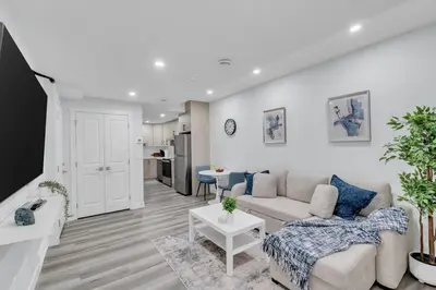 a living room with a couch and a table at Basement in Calgary - 10 Mins from Calgary Airport in Calgary