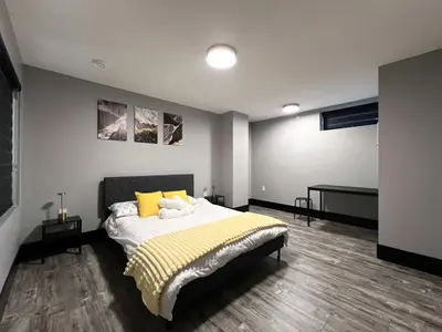 a bedroom with a large bed with yellow pillows at Spacious 2-Bedroom Retreat in Burnaby in Burnaby