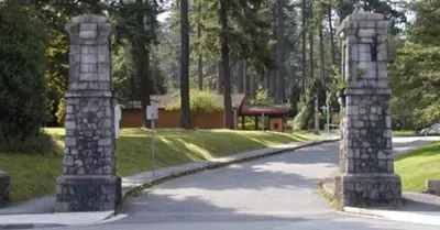 a road with two stone pillars in a park at Spacious 2-Bedroom Retreat in Burnaby in Burnaby