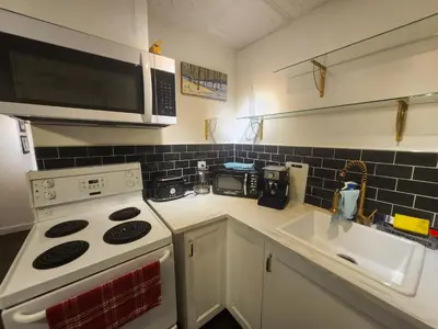 a kitchen with a stove and a microwave at One Bedroom Suite in perfect location Vancouvers Mount Pleasant in Vancouver