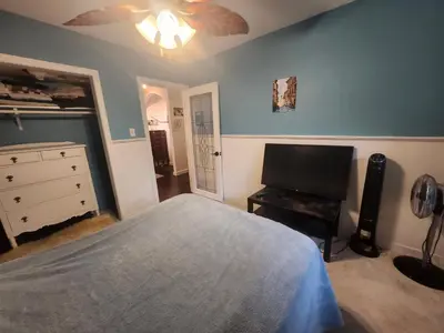 a bedroom with a bed and a dresser and a television at One Bedroom Suite in perfect location Vancouvers Mount Pleasant in Vancouver