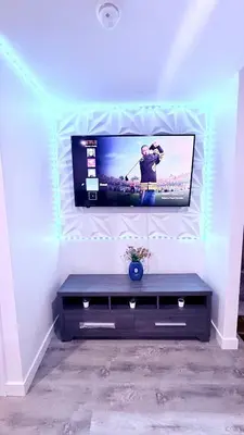 a living room with a tv on a wall at Modern Comfort Stay Near Airport in Edmonton