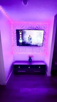 a living room with a tv and purple lights at Modern Comfort Stay Near Airport in Edmonton