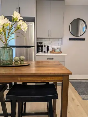 a kitchen with a wooden table and a refrigerator at Oakview Hideaway in Victoria