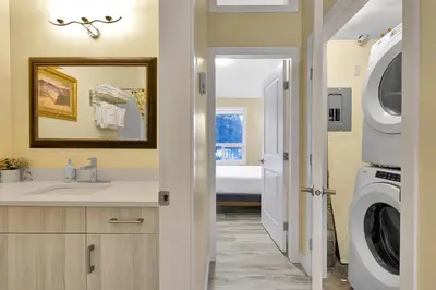 a bathroom with a sink and a washing machine at banff woods lodge in Canmore