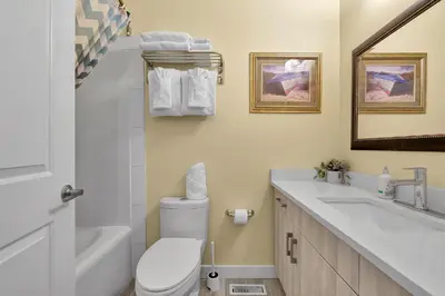 a bathroom with a white toilet and a sink at banff woods lodge in Canmore