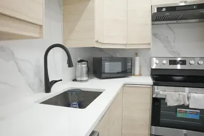 a kitchen with a sink and a microwave at 5003R New Luxury Walkout Suite Near Calgary University in Calgary