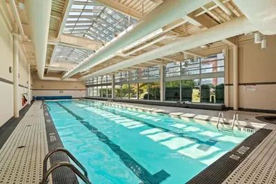 a large indoor swimming pool with a large ceiling at Cozy Urban Living! 2 mins from BC place, private parking ! in Vancouver
