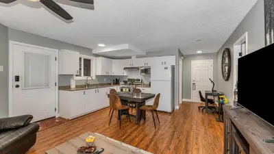 a kitchen and living room with a table and chairs at Knockan Hill Rentals - Ground Floor Suite in Victoria
