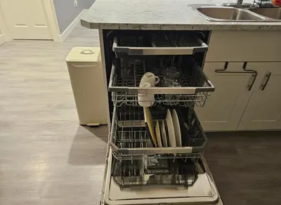 a dishwasher with utensils in it in a kitchen at Cowichan Valley Retreat with Sauna & Free EV Charger in Duncan