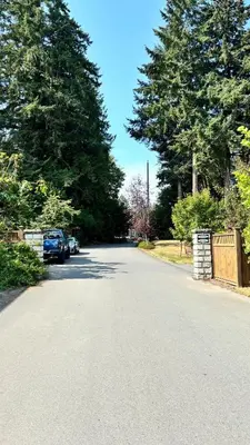 a street with a car parked on the side of the road at Cowichan Valley Retreat with Sauna & Free EV Charger in Duncan