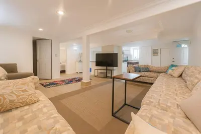 a living room with a couch and a television at Melrose Place Poolside Hideaway Heated Pool All Year Ideal for Groups Sleeps 6 plus in Victoria