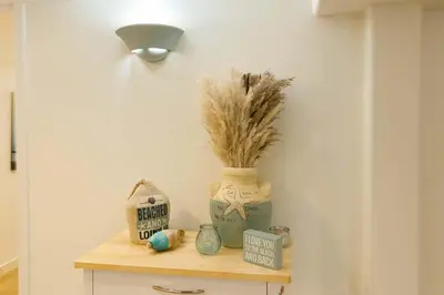 a shelf with a vase and some items on it at Melrose Place Poolside Hideaway Heated Pool All Year Ideal for Groups Sleeps 6 plus in Victoria