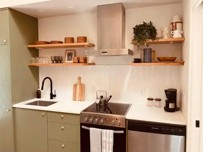 a kitchen with a sink and a stove at Fern's Edge in Port Renfrew