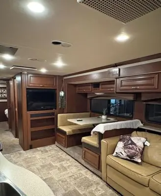 a living room with a couch and a table at Prairie Junction Resort - Furnished RV Apartments in Stettler