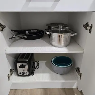 a kitchen shelf with pots and pans on it at Spacious 2 Bedroom Suite in Edmonton in Edmonton