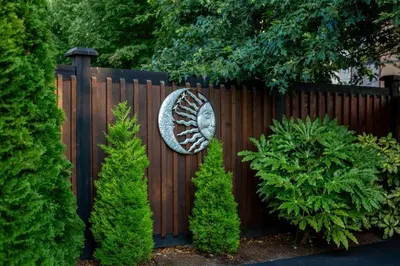 a wooden fence with a fish sign on it at Sidney Solace 1BR Suite Minutes from Waterfront in Sidney