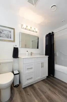 a white bathroom with a sink and a toilet at Sidney Solace 1BR Suite Minutes from Waterfront in Sidney