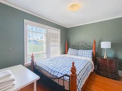 a bedroom with a bed and a window at Cozy Private Bedroom Suite in UBC Campus in Vancouver
