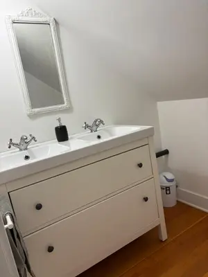 a bathroom with a white sink and a mirror at Charming Victoria Character Home-Pet Friendly in Victoria